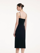 the back view of a lady in black slip dress